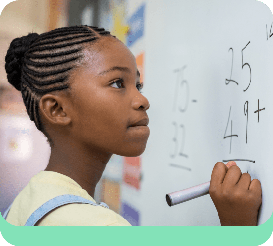 Student writing on whiteboard